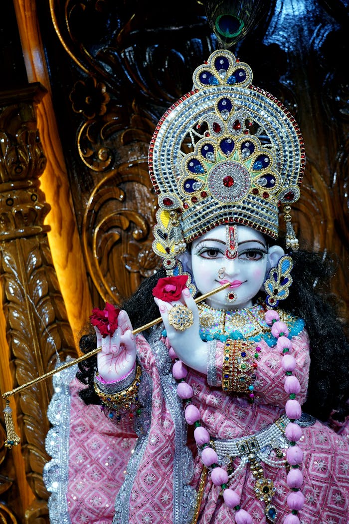 Mastering the First Impression: Your intriguing post title goes here Intricate statue of Krishna adorned in colorful attire, holding flute and roses, showcasing Hindu artistry.