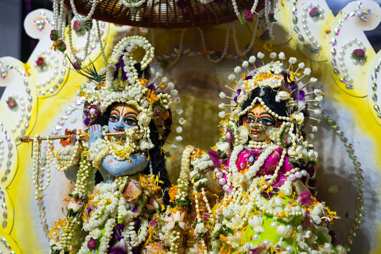 Home Vibrant Hindu deities statues embellished with floral decorations, symbolizing spiritual reverence.