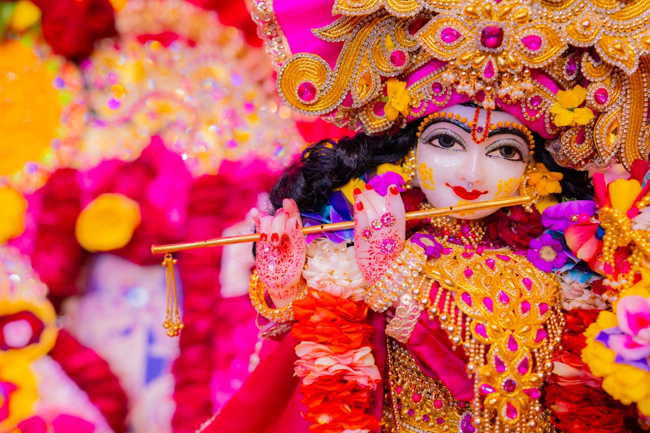 Home Vibrant Krishna idol adorned with intricate jewelry and flowers holding a flute.