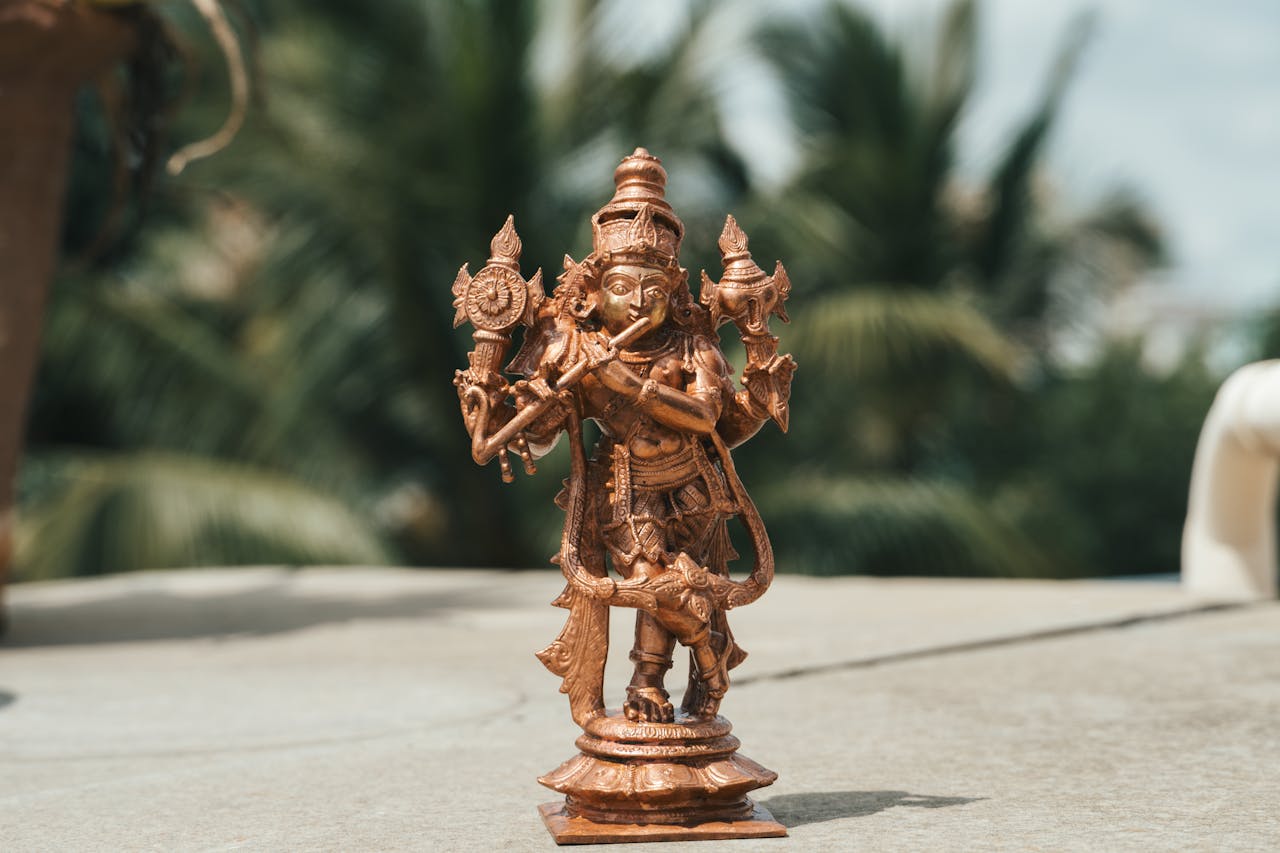 About Us A detailed brass statue of a Hindu deity photographed outdoors in Bengaluru, India.